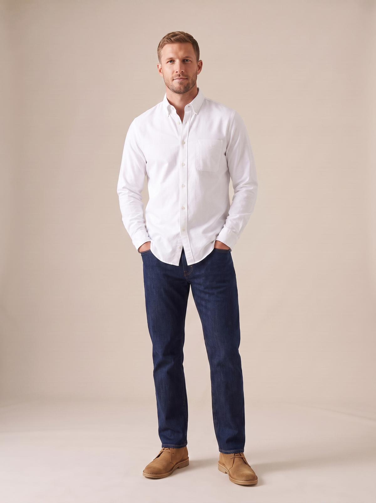 Man in a white oxford shirt with his hands in his pockets